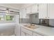 Charming kitchen with white cabinets, ample counter space, and a view into the dining area at 11415 Central E Dr, Carmel, IN 46032