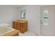 Functional laundry room with sink, wood cabinets, and a window offering natural light at 11415 Central E Dr, Carmel, IN 46032
