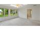 Bright room featuring carpeted floors, white walls, a ceiling fan, and large windows providing lots of natural light at 11415 Central E Dr, Carmel, IN 46032