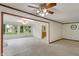 Spacious living room featuring carpeted floors, white walls, a ceiling fan, and lots of natural light at 11415 Central E Dr, Carmel, IN 46032