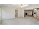 Spacious living room with carpeted floor, white walls, and access to the kitchen and another room at 11415 Central E Dr, Carmel, IN 46032