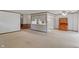 Open-concept living space with neutral tones, carpet, and a vintage wooden hutch at 11415 Central E Dr, Carmel, IN 46032