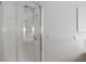Modern bathroom shower featuring sleek glass door and a chrome shower head at 11415 Central E Dr, Carmel, IN 46032