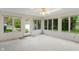 Sunroom with carpeted floor, multiple windows, and a door that provides access to the backyard at 11415 Central E Dr, Carmel, IN 46032