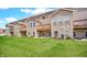 View of a lush green backyard with a well-maintained lawn and private decks, perfect for outdoor enjoyment at 11436 Mossy Ct # 101, Fishers, IN 46037