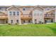 View of a lush green backyard with a well-maintained lawn and a private deck, perfect for outdoor enjoyment at 11436 Mossy Ct # 101, Fishers, IN 46037