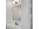 Bright bathroom features a modern vanity, framed mirror, and stylish lighting fixtures at 11436 Mossy Ct # 101, Fishers, IN 46037