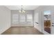 Bright dining room with wood floors, chandelier, large windows, and a door leading to the outdoor deck at 11436 Mossy Ct # 101, Fishers, IN 46037