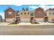 Charming townhome exteriors feature brick facades, attached garages, and professionally landscaped yards with flowering trees at 11436 Mossy Ct # 101, Fishers, IN 46037