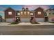 Charming townhome exteriors feature brick facades, attached garages, and professionally landscaped yards with flowering trees at 11436 Mossy Ct # 101, Fishers, IN 46037