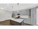 Modern kitchen features gray cabinetry, stainless steel appliances, and an island with a white countertop at 11436 Mossy Ct # 101, Fishers, IN 46037