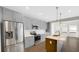 Modern kitchen with stainless steel appliances, gray cabinets, and an island sink at 11436 Mossy Ct # 101, Fishers, IN 46037