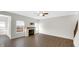 Bright living room features a fireplace, large windows, and modern wood flooring at 11436 Mossy Ct # 101, Fishers, IN 46037