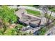 Aerial view of the home shows the roof, lawn, and proximity to surrounding trees at 11626 Forest Dr, Carmel, IN 46033