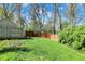 A fenced backyard with a lush green lawn and mature trees at 11626 Forest Dr, Carmel, IN 46033