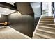 Finished basement stairs with plush carpeting, black walls, and view of finished basement at 11626 Forest Dr, Carmel, IN 46033