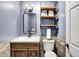 Powder room features a tiled accent wall, modern shelves, vanity, and updated lighting at 11626 Forest Dr, Carmel, IN 46033