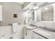 Bathroom with dual sinks, granite countertops, framed mirrors and decorative wall art at 11626 Forest Dr, Carmel, IN 46033