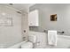Bathroom with white subway tile, shower niche, and tiled tub with shower at 11626 Forest Dr, Carmel, IN 46033
