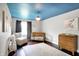 Bedroom showcasing decorated ceiling, natural lighting, and wooden crib and dresser at 11626 Forest Dr, Carmel, IN 46033