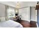 Bedroom featuring hardwood floors, a modern light fixture, a closet, and desk area at 11626 Forest Dr, Carmel, IN 46033