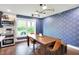 Stylish dining area featuring a modern table, hardwood floors, and designer wallpaper at 11626 Forest Dr, Carmel, IN 46033