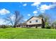 Beautiful home exterior with a sprawling green lawn and mature trees in a tranquil setting at 11626 Forest Dr, Carmel, IN 46033