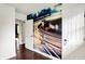 Hallway with hardwood flooring and unique wall art, accentuated by natural light at 11626 Forest Dr, Carmel, IN 46033