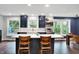 Bright kitchen with a center island, navy cabinets, and stainless steel appliances at 11626 Forest Dr, Carmel, IN 46033