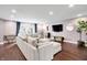 Spacious living room featuring hardwood floors, stylish decor, and a comfortable sectional sofa at 11626 Forest Dr, Carmel, IN 46033