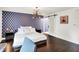 Main bedroom showcasing modern design, barn door and light fixture, and wood flooring at 11626 Forest Dr, Carmel, IN 46033