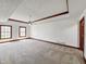 Spacious bedroom with tray ceilings, neutral carpet, and ample natural light from two windows at 11642 Old Stone Dr, Indianapolis, IN 46236
