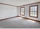 Inviting bedroom with neutral carpeting and two large windows, offering abundant natural light at 11642 Old Stone Dr, Indianapolis, IN 46236