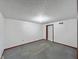 Simple bedroom with gray carpet and a white door at 11642 Old Stone Dr, Indianapolis, IN 46236