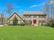 Stunning brick home featuring a manicured lawn and a vibrant red front door at 11642 Old Stone Dr, Indianapolis, IN 46236