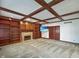 Warm living room with coffered ceilings, custom built-ins, and a decorative fireplace at 11642 Old Stone Dr, Indianapolis, IN 46236