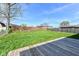 Expansive backyard with a well-maintained lawn and a wooden deck perfect for outdoor entertaining at 1216 N Whittier Pl, Indianapolis, IN 46219