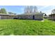 Backyard featuring a stone house and an expansive yard at 1216 N Whittier Pl, Indianapolis, IN 46219
