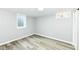 Finished basement with gray walls and gray flooring, a small window and a door to another room at 1216 N Whittier Pl, Indianapolis, IN 46219