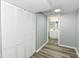 Finished basement featuring gray walls, gray flooring and white closet with a view into the bathroom at 1216 N Whittier Pl, Indianapolis, IN 46219