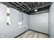 Unfinished basement with painted gray walls, bare ceiling and gray floors showing pipes and utilities at 1216 N Whittier Pl, Indianapolis, IN 46219