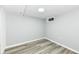 Finished basement featuring gray walls, recessed lighting and gray flooring with a small window at 1216 N Whittier Pl, Indianapolis, IN 46219