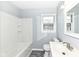 Bright bathroom showcasing a shower-tub combo and a white vanity at 1216 N Whittier Pl, Indianapolis, IN 46219