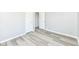 Bedroom featuring light grey walls, white trim and light wood flooring at 1216 N Whittier Pl, Indianapolis, IN 46219