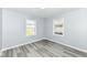 Sunlit bedroom featuring grey walls and light wood flooring at 1216 N Whittier Pl, Indianapolis, IN 46219