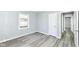 Cozy bedroom with natural light, featuring grey walls, white trim, and updated flooring at 1216 N Whittier Pl, Indianapolis, IN 46219