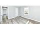 Bright bedroom featuring grey walls and light wood flooring at 1216 N Whittier Pl, Indianapolis, IN 46219
