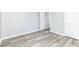 Well-lit bedroom featuring grey walls and light wood flooring at 1216 N Whittier Pl, Indianapolis, IN 46219
