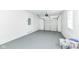 Spacious two car garage with a garage door, a service door and gray painted floors at 1216 N Whittier Pl, Indianapolis, IN 46219