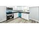 Bright kitchen featuring stainless steel appliances, white cabinetry and gray walls at 1216 N Whittier Pl, Indianapolis, IN 46219